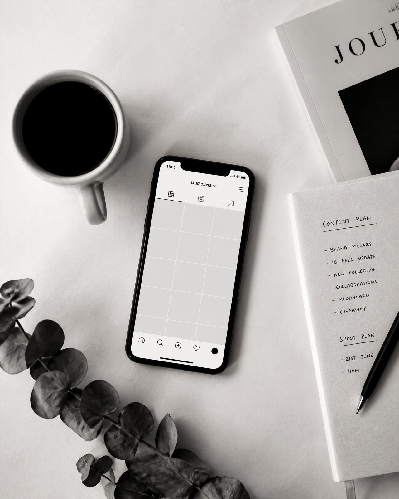 Flat lay of a phone showing an Instagram grid beside a handwritten content plan